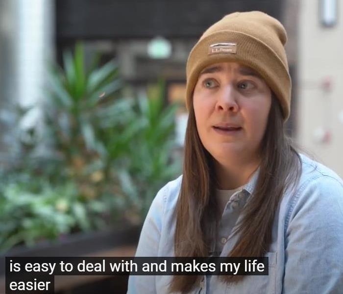 A woman in a beanie with the subtitle "is easy to deal with and makes my life easier."