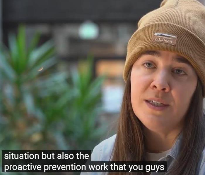A woman in a beanie with the subtitle "situation but also the proactive prevention work that you guys."